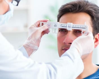 Illustration of a person helping another measure their PD